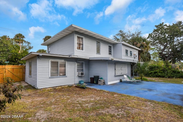 rear view of house featuring cooling unit and a patio area