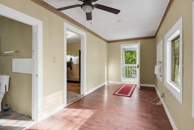 entryway with ceiling fan, crown molding, and hardwood / wood-style flooring