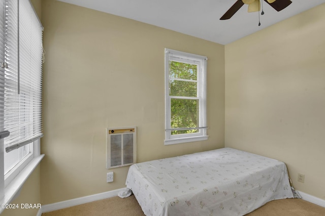 bedroom featuring carpet flooring, multiple windows, and ceiling fan