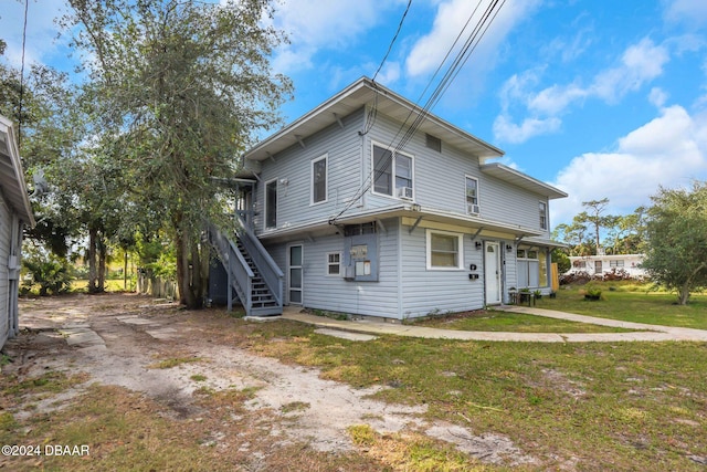 back of house with a lawn