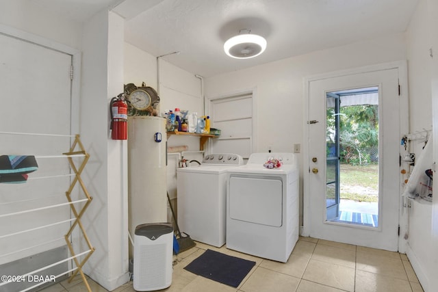 laundry room featuring light tile patterned floors and washer and clothes dryer