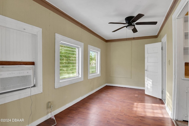 empty room with ceiling fan, dark hardwood / wood-style flooring, and ornamental molding