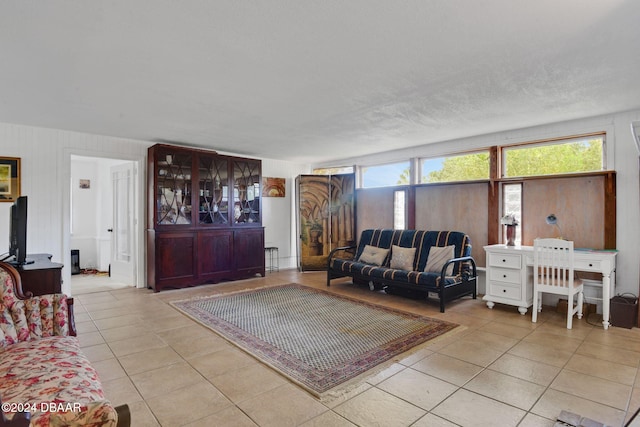 living room with plenty of natural light and light tile patterned floors