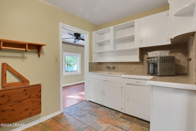 kitchen featuring backsplash, white cabinetry, ceiling fan, and sink