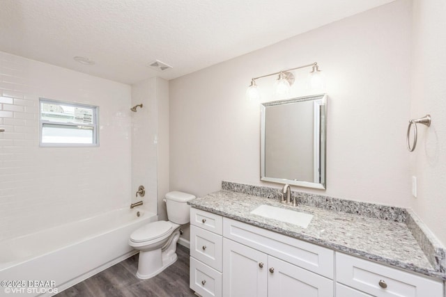 495 6th St, Holly Hill, FL 32117 - full bath with wood finished floors, vanity, washtub / shower combination, and a textured ceiling