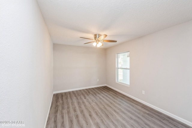 495 6th St, Holly Hill, FL 32117 - empty room with light wood-style floors, ceiling fan, and a textured ceiling