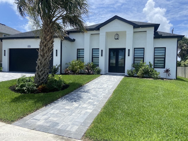 142 Sandpiper Ridge Dr, Ormond Beach, FL 32176 - view of front of property featuring french doors, stucco siding, an attached garage, and a front lawn