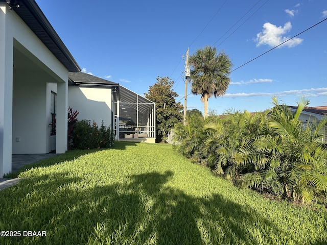 142 Sandpiper Ridge Dr, Ormond Beach, FL 32176 - view of green lawn with a lanai