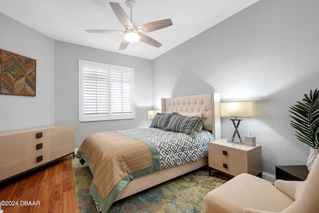 bedroom with dark wood-type flooring and ceiling fan