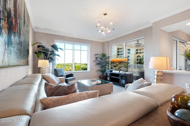 living room with a notable chandelier and ornamental molding