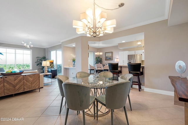 dining room with light tile patterned flooring, ornamental molding, and a notable chandelier