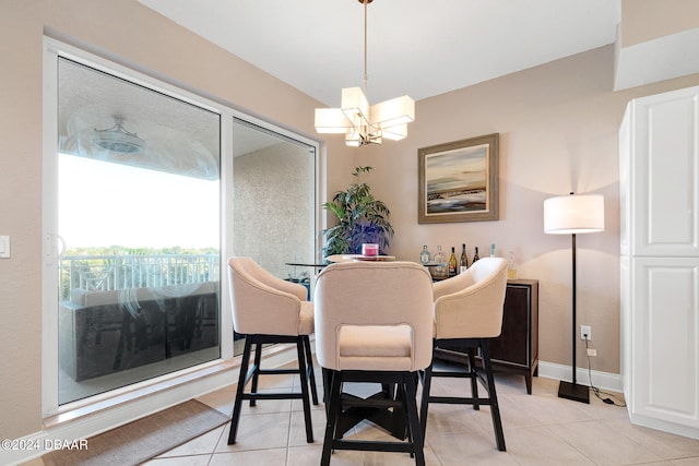 dining area with a chandelier and light tile patterned floors