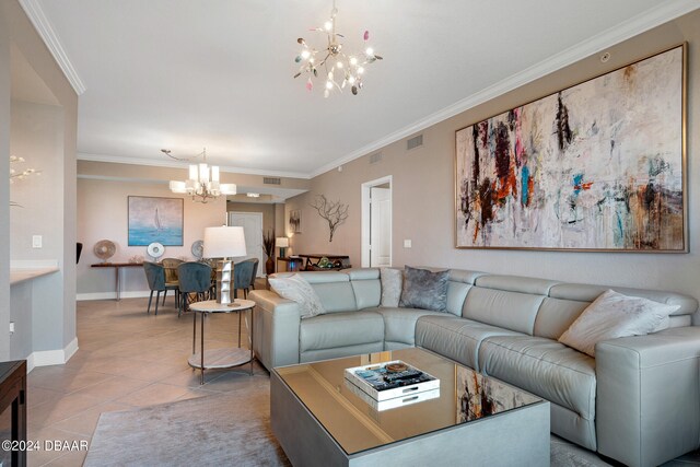 living room featuring ornamental molding, a notable chandelier, and tile patterned floors