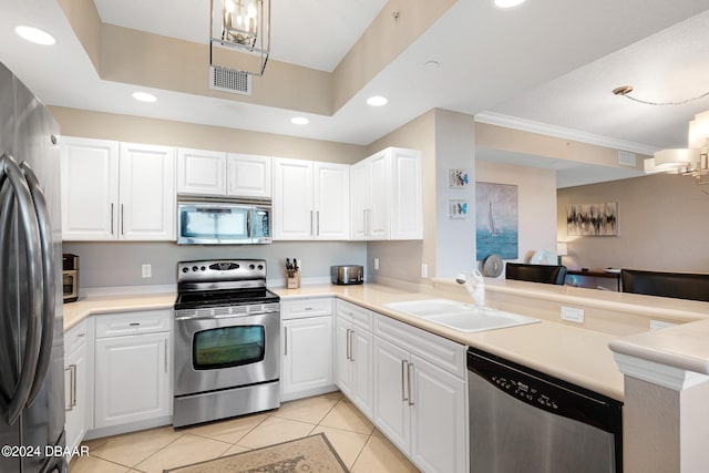 kitchen featuring kitchen peninsula, appliances with stainless steel finishes, and white cabinets