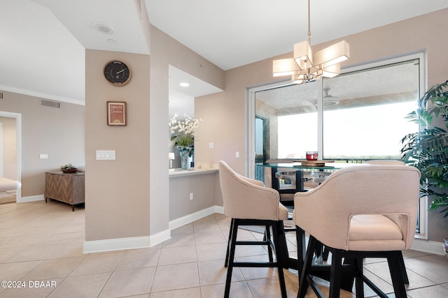 tiled dining room featuring a notable chandelier