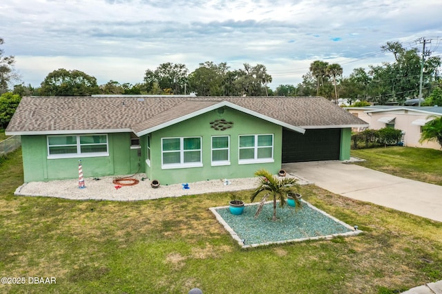 back of property featuring a yard and a garage