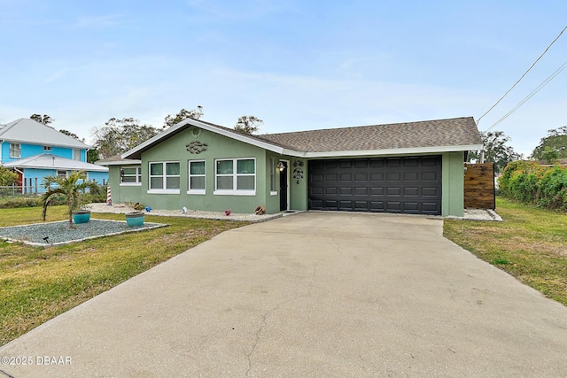 view of front of property with a front yard and a garage