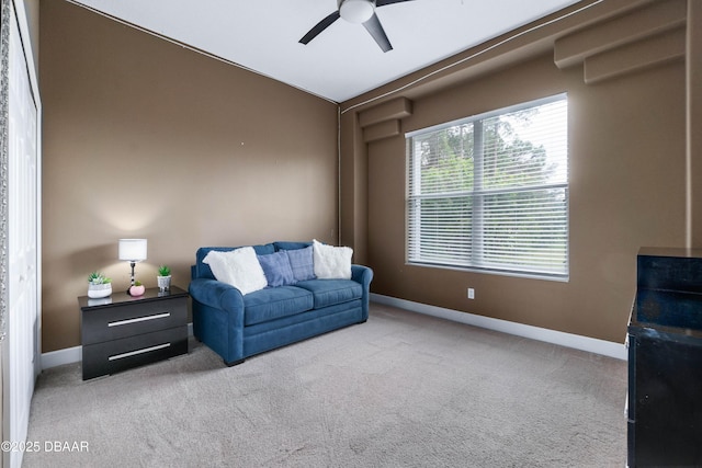 carpeted living room featuring vaulted ceiling and ceiling fan