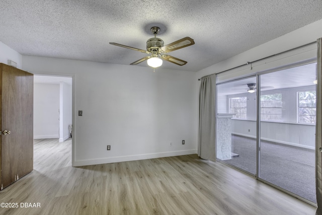 spare room featuring a ceiling fan, a textured ceiling, and wood finished floors