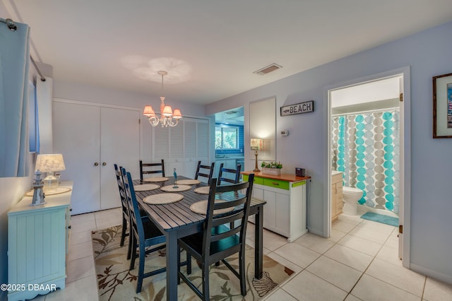4405 Sea Mist Dr Unit 218, New Smyrna Beach, FL 32169 - dining space featuring a chandelier and light tile patterned flooring