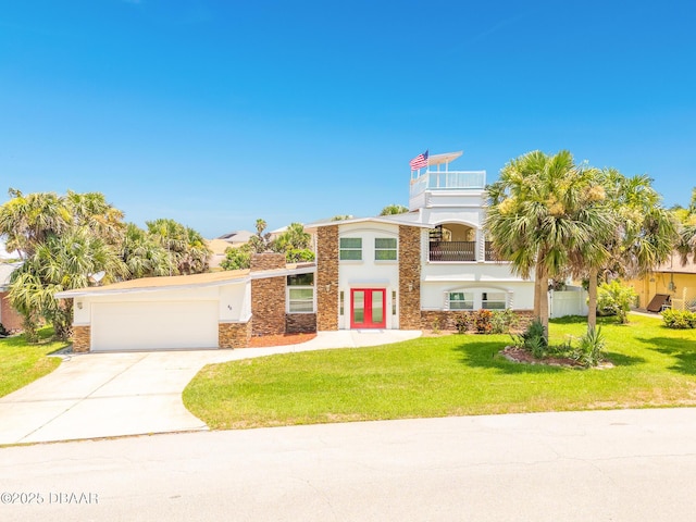 46 Oceanview Ave, Ponce Inlet, FL 32127 - view of front of house featuring stone siding, a balcony, stucco siding, a garage, and driveway