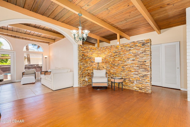 46 Oceanview Ave, Ponce Inlet, FL 32127 - living area with wooden ceiling, a chandelier, wood finished floors, and arched walkways