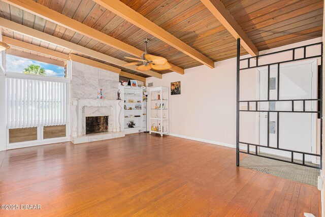 46 Oceanview Ave, Ponce Inlet, FL 32127 - unfurnished living room with wood finished floors, a wooden ceiling with exposed beams, a fireplace, and ceiling fan
