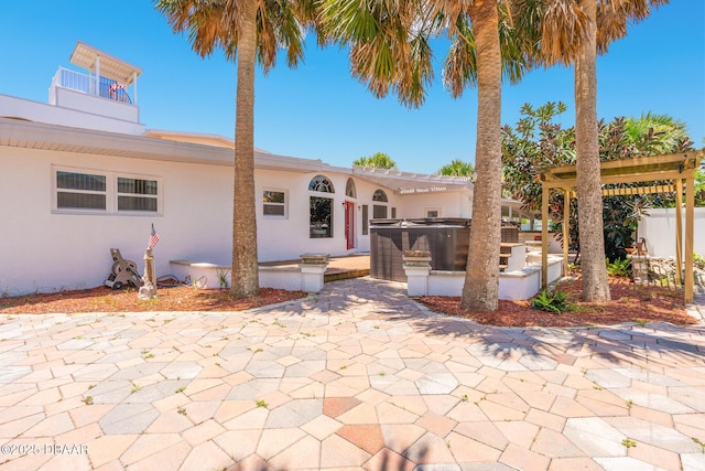 46 Oceanview Ave, Ponce Inlet, FL 32127 - view of front of home with a patio, stucco siding, and a hot tub