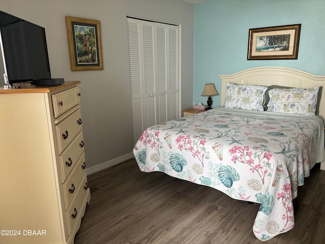 bedroom with dark hardwood / wood-style floors and a closet