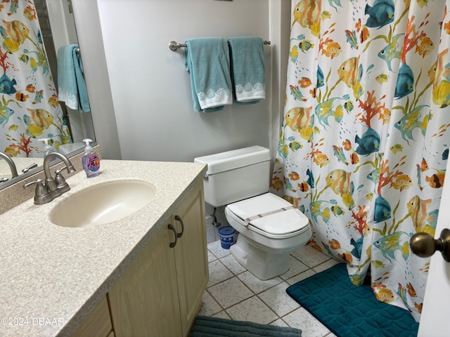 bathroom with vanity, a shower with shower curtain, tile patterned flooring, and toilet