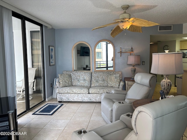 tiled living room with a textured ceiling and ceiling fan