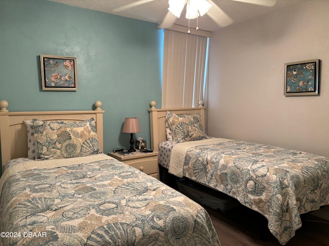 bedroom with a textured ceiling and ceiling fan