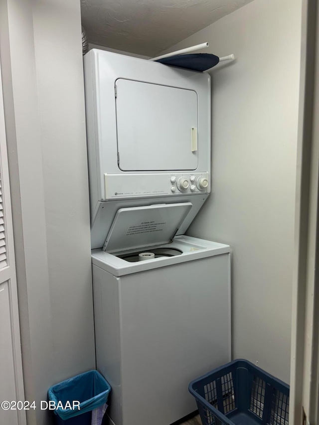 laundry area with stacked washer and dryer