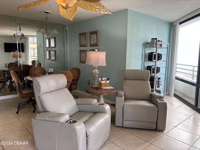 living room featuring a textured ceiling, a wealth of natural light, and light tile patterned floors