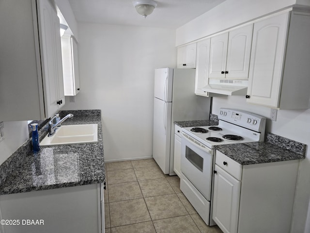 kitchen featuring white electric stove, sink, light tile patterned floors, and white cabinets