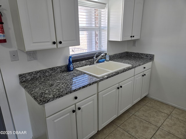 kitchen featuring sink, white cabinets, and light tile patterned flooring