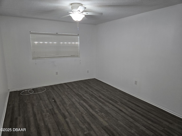 spare room with ceiling fan, dark hardwood / wood-style floors, and a textured ceiling