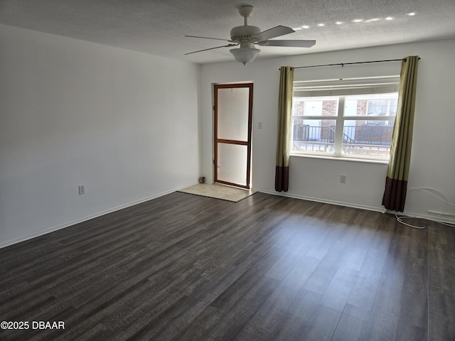 spare room with ceiling fan, a textured ceiling, and dark hardwood / wood-style flooring