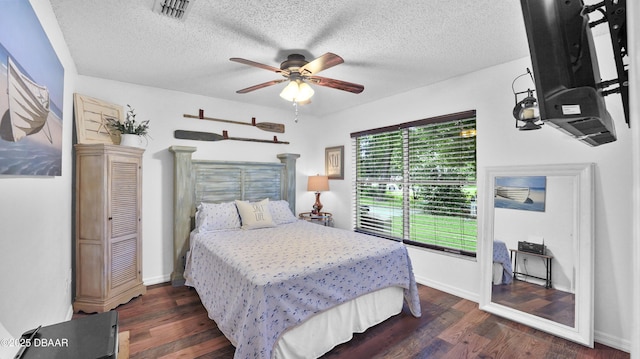 156 Holly Hill Ct, New Smyrna Beach, FL 32168 - bedroom with dark wood-style floors, a textured ceiling, and ceiling fan