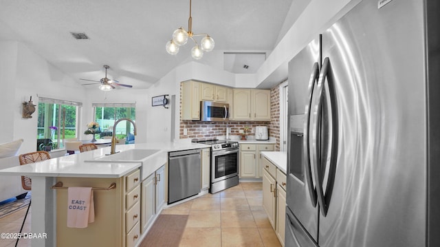 156 Holly Hill Ct, New Smyrna Beach, FL 32168 - kitchen featuring stainless steel appliances, cream cabinetry, backsplash, light tile patterned flooring, and light countertops