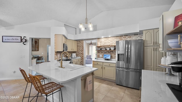 156 Holly Hill Ct, New Smyrna Beach, FL 32168 - kitchen with appliances with stainless steel finishes, vaulted ceiling, light tile patterned floors, a kitchen breakfast bar, and light countertops