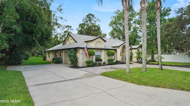 156 Holly Hill Ct, New Smyrna Beach, FL 32168 - view of front facade featuring driveway, stucco siding, a shingled roof, and an attached garage