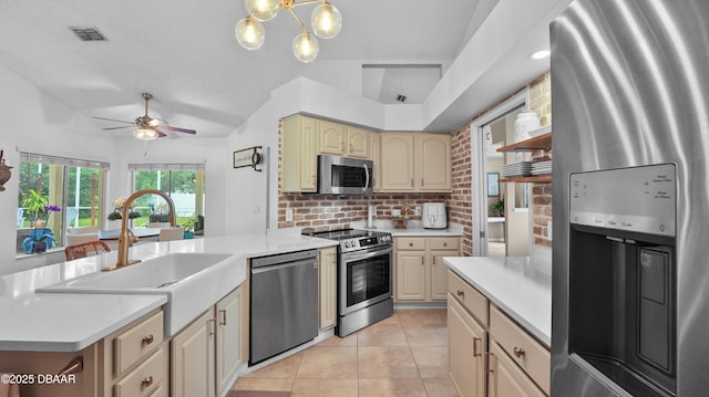 156 Holly Hill Ct, New Smyrna Beach, FL 32168 - kitchen featuring stainless steel appliances, tasteful backsplash, light countertops, a ceiling fan, and cream cabinets