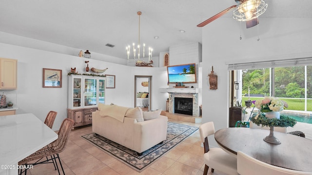 156 Holly Hill Ct, New Smyrna Beach, FL 32168 - living room with high vaulted ceiling, a glass covered fireplace, light tile patterned flooring, ceiling fan, and a chandelier