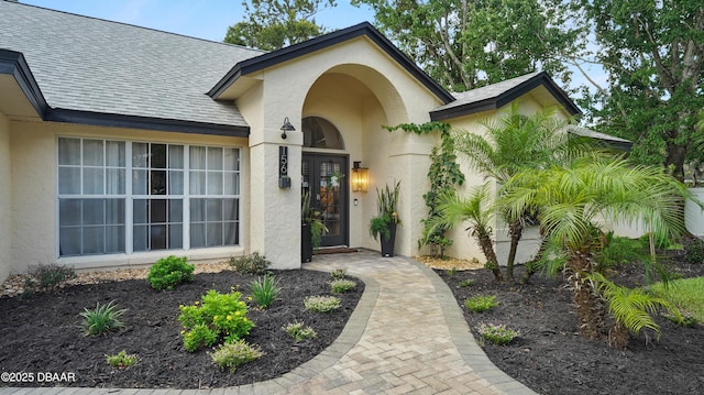 156 Holly Hill Ct, New Smyrna Beach, FL 32168 - entrance to property featuring stucco siding and a shingled roof