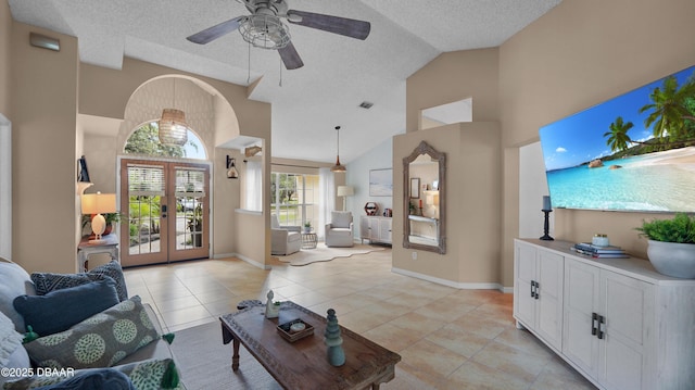 156 Holly Hill Ct, New Smyrna Beach, FL 32168 - living room featuring french doors, a textured ceiling, a ceiling fan, high vaulted ceiling, and light tile patterned floors