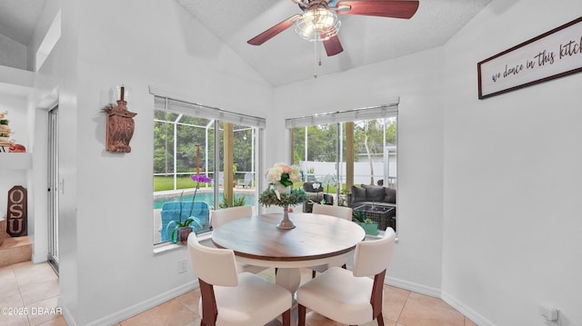 156 Holly Hill Ct, New Smyrna Beach, FL 32168 - dining area with lofted ceiling, a ceiling fan, healthy amount of natural light, and light tile patterned floors