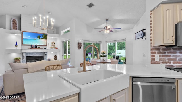 156 Holly Hill Ct, New Smyrna Beach, FL 32168 - kitchen featuring stainless steel dishwasher, open floor plan, light countertops, a ceiling fan, and lofted ceiling