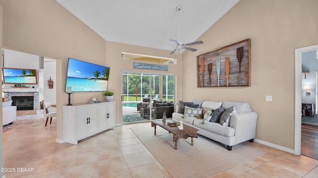 156 Holly Hill Ct, New Smyrna Beach, FL 32168 - living room with high vaulted ceiling, ceiling fan, light tile patterned floors, and a glass covered fireplace