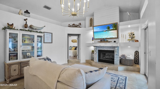 156 Holly Hill Ct, New Smyrna Beach, FL 32168 - living area featuring a chandelier, a glass covered fireplace, tile patterned floors, and a high ceiling